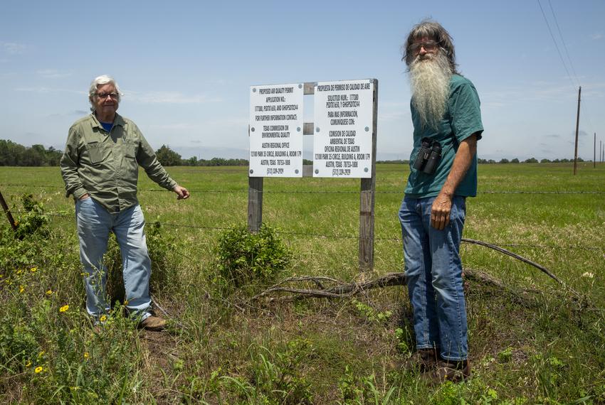 Travis Brown and Hugh Brown, no relation, stand by a sign marking the site of a proposed 1,200 MW gas-fired power plant in their tiny town of Blue.